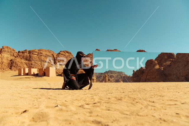 التطور والتقدم العمراني في المملكة العربية السعودية, رجل عربي خليجي سعودي يرتدي زي يوم التأسيس يمسك بيده التراب, انعكاس الطبيعة الصخرية على مسرح مرايا في محافظة العلا, مناطق السياحة المشهورة, يوم بدينا 1727م, ذكرى تأسيس الدولة السعودية الأولى في 22 فبراير