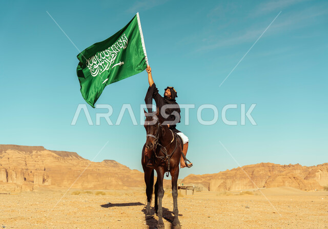 Our Day 1727 AD, the founding of the first Saudi state on February 22, Flag Day on March 11, famous tourist attractions, riding on horseback in the tourist governorate of Al-Ula, a Saudi Gulf Arab knight wearing the founding uniform, riding a purebred brown horse, raising the Kingdom’s flag on National Day on the 23rd. September