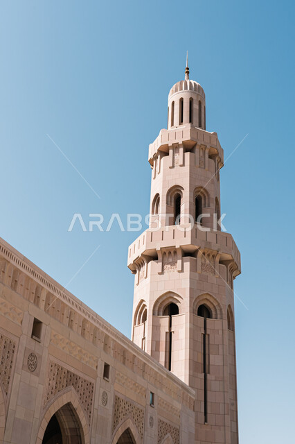 Famous Islamic mosques and landmarks, calling Muslims to pray, worship and draw closer to God, architectural art in Islamic style, a picture close to the minaret of the Sultan Qaboos Mosque in the city of Nizwa in the Sultanate of Oman, holy religious tourism places