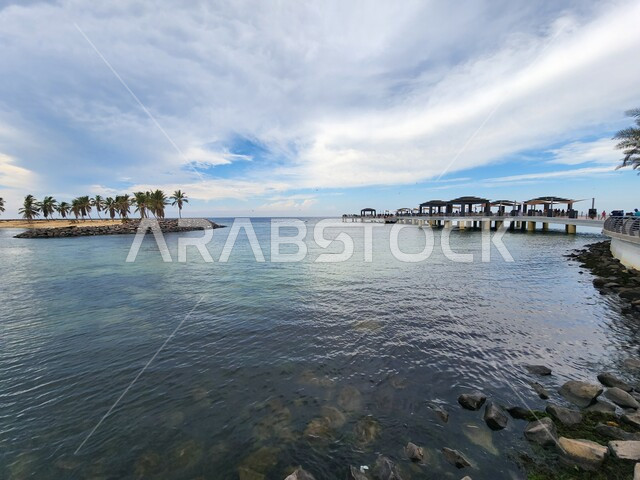 A view of the Jeddah waterfront in the Kingdom of Saudi Arabia, the new Jeddah Corniche Landscape, famous coastal tourist places in Jeddah, the Red Sea coast, green palm trees, landmarks that attract tourists from all over the world.