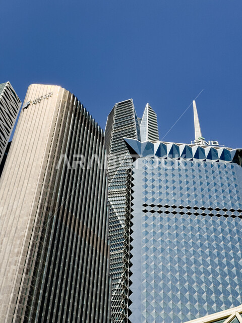 Saudi urban development and progress, a picture from below of the King Abdullah Financial Center (CAFD) in the city of Riyadh, towers and skyscrapers, the ideal destination for money and business with international standards, famous landmarks and places, economic and commercial facilities and buildings.