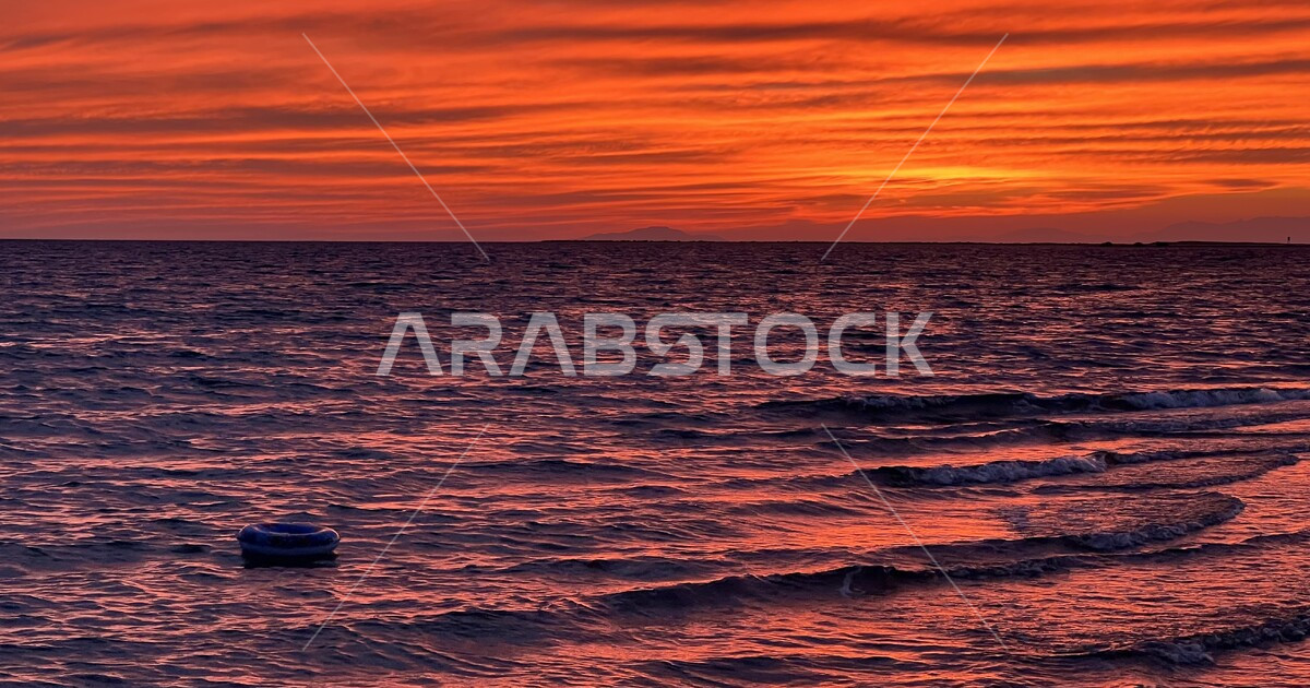 Enjoying swimming using a life raft, natural sunset views on the shore ...