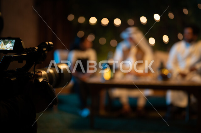 Exchanging conversations and socializing between individuals, decorations and decorations for Islamic occasions and holidays, behind the scenes of a photo session of a Saudi Gulf Arab family spending enjoyable times in an outdoor session in one of the chalets, a happy family atmosphere in the holy month of Ramadan