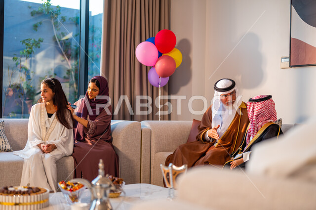 الاحتفال بالعيد مع الأبناء، الاعتناء بالمظهر الخارجي، أم عربية خليجية سعودية تقوم بتصفيف شعر ابنتها، ارتداء الأزياء التقليدية في الأعياد والمناسبات الدينية، ايماءات البهجة والسرور