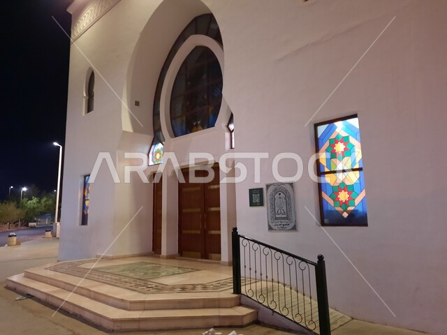 Islamic decorations and distinguished architectural art in the modern style, a close-up of the entrance to the Al-Arish Mosque in Badr City near Medina at night, worship and getting closer to God, landmarks and sacred religious places in the Kingdom of Saudi Arabia