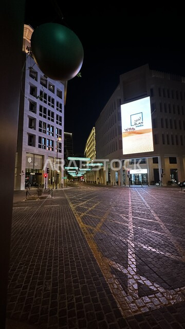 A cultural hub for regional and international talent, Msheireb Downtown in Doha, commercial and residential towers and facilities illuminated at night, shopping malls and fun events, the architectural art of buildings in the heritage style of the State of Qatar