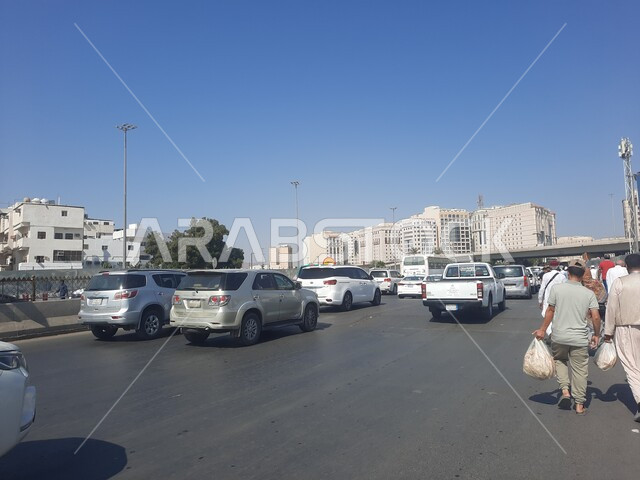 Islamic religious places and landmarks, the roads surrounding the Prophet’s Mosque, car traffic in the streets of Medina, the architectural art of buildings and towers.