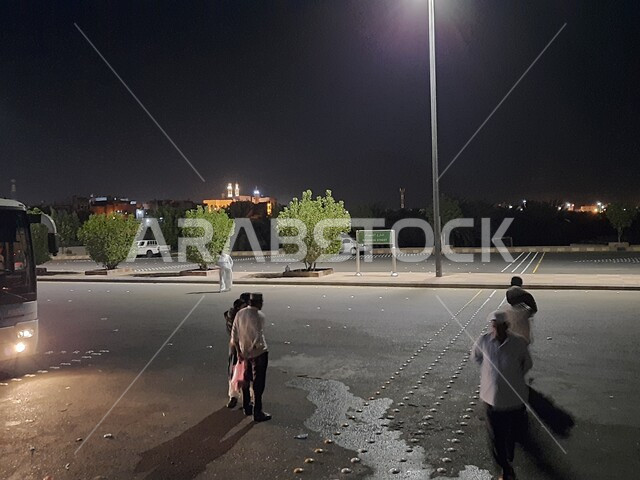 Visitors’ arrival to the headquarters of the martyrs of the Battle of Badr in Medina at night, popular heritage and historical places, paved roads and streets, famous Islamic religious areas and landmarks in the Kingdom of Saudi Arabia, interest in afforestation and agriculture