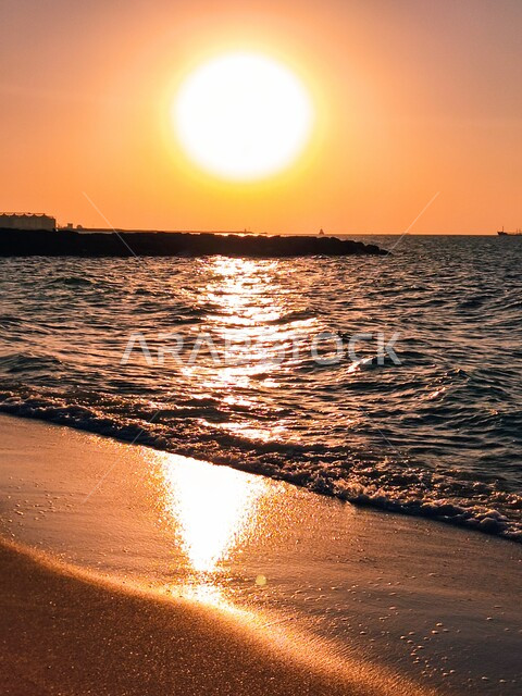 The beach coasts and waterfront in Sharjah, a destination for tourists from all over the world, famous coastal tourist attractions and places in the United Arab Emirates, enjoying the calm sea waves at sunset