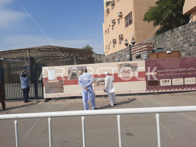  مشروع تطوير وتأهيل المواقع التاريخية الاسلامية في المدينة المنورة بالمملكة العربية السعودية، تجمع السياح بجانب لافتة اعلانية، بئر غرس في المدينة المنورة،معالم التاريخية سياحية