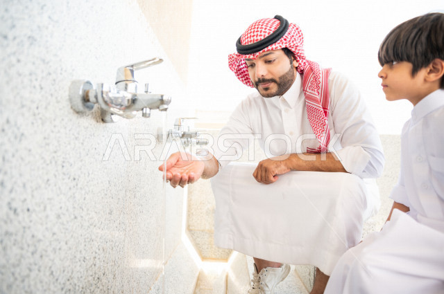 Learn how to perform ablution and purification for a small child with his father inside the mosque, a small adult child learns how to perform ablution, worship and draw closer to God, teach prayer to children