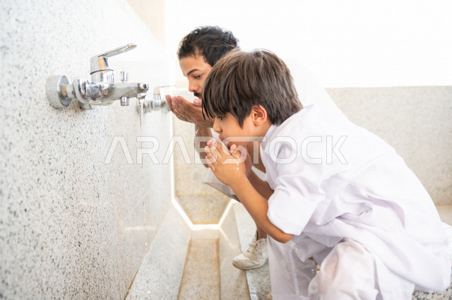 Learn how to perform ablution and purification for a small child with his father inside the mosque, a small adult child learns how to perform ablution, worship and draw closer to God, teach prayer to children