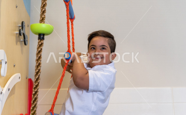 A Saudi child in kindergartens and incubators, who performs many fun and different activities, a child with special needs, a group of individual activities that the child of determination does, integrating people with special needs in kindergartens and in