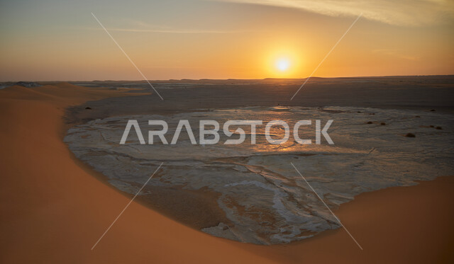 The view of the sky filled with white clouds at sunset, famous tourist places, ancient historical monuments, attracting and attracting tourists, sand dunes in the Saudi desert, the merging of white and golden sand.