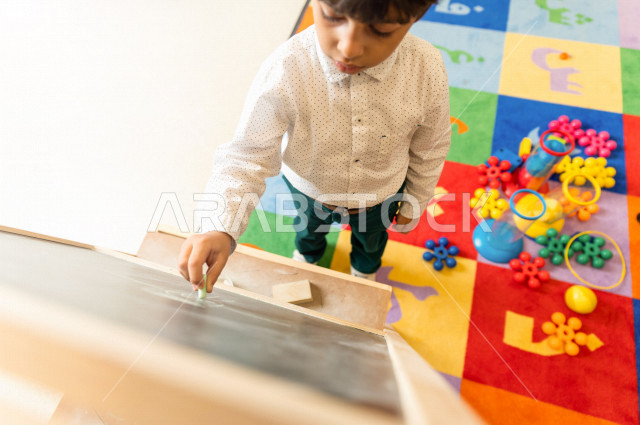 A Saudi child in kindergartens and incubators, who performs many fun and different activities, a child with special needs, a group of individual activities that the child of determination does, integrating people with special needs in kindergartens and in