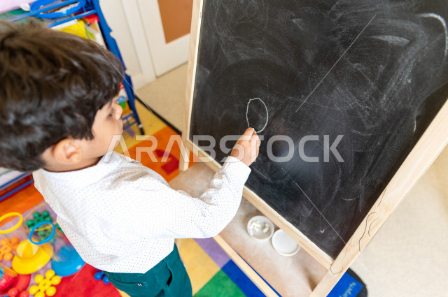 A Saudi child in kindergartens and incubators, who performs many fun and different activities, a child with special needs, a group of individual activities that the child of determination does, integrating people with special needs in kindergartens and in