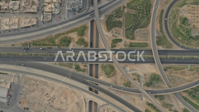 Green trees and plants, modern geometric art for the streets of Riyadh during the day, the transportation network and traffic on the roads of the Kingdom of Saudi Arabia.