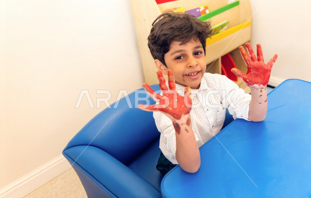 A Saudi child in kindergartens and incubators, who performs many fun and different activities, a child with special needs, a group of individual activities that the child of determination does, integrating people with special needs in kindergartens and in