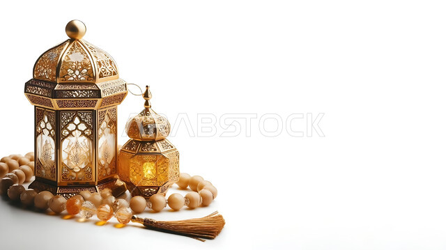 Traditional lanterns and antiques to celebrate the advent of the holy month of Ramadan, a Ramadan and Islamic spiritual atmosphere, decorations and decorations for holidays and religious occasions, a luminous decorative metal Arabic lantern next to a rosary of beads, a white background.