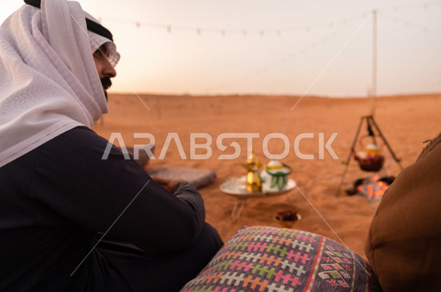A young Saudi on a wild walk at sunset in the desert of  saudi arabia
