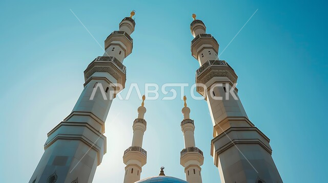 Worship and closeness to God, distinguished architectural art and Islamic decoration in the modern style, a close-up of minarets and domes in the daytime, landmarks and sacred religious places in the Kingdom of Saudi Arabia
