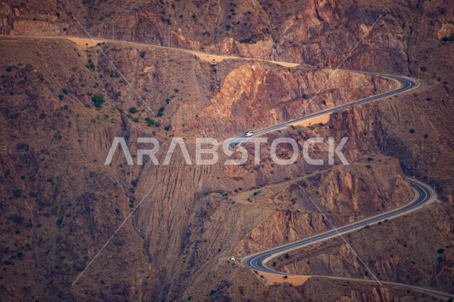 Rugged and winding mountain roads, mountain ranges in the Asir region during the day, natural desert highlands in the city of Abha, famous historical tourist places in the Kingdom of Saudi Arabia.