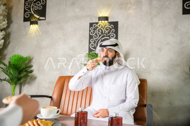   , Saudi business partners are enjoying an assortment of desserts and coffee at a cafe , enjoying a peaceful environment at a local cafe  
