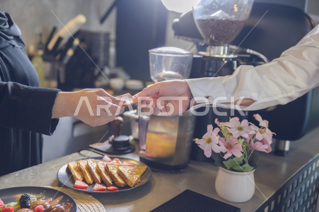  , A person pays the bill using his smart phone , using a credit card terminal for payment , ease of electronic payment 