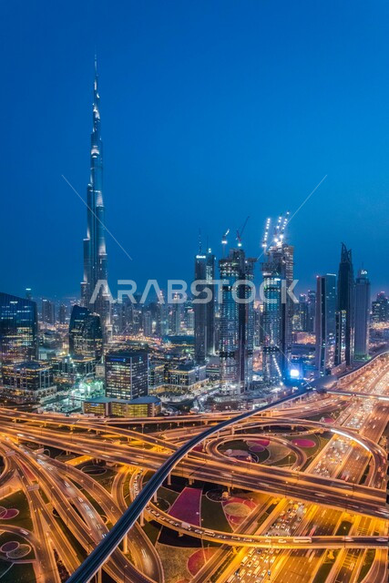 The network of paved roads and streets, advanced architectural engineering for commercial and residential facilities, an aerial photo of the bridges in front of Burj Khalifa and skyscrapers in the Emirate of Dubai in the United Arab Emirates, famous landmarks and tourist places.