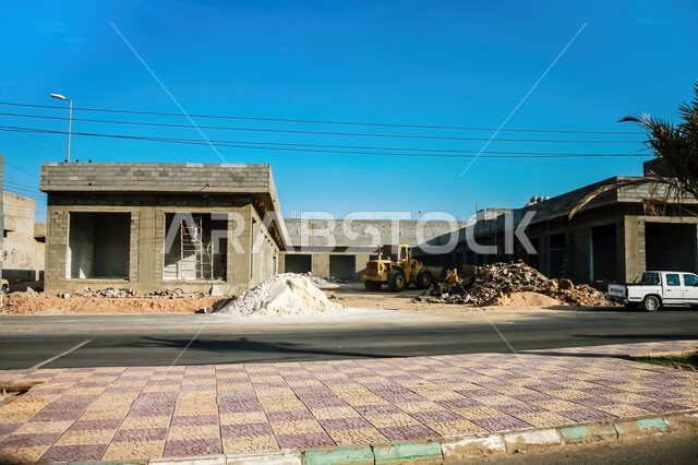 A building under construction in the village of Umm Al-Dum in Al-Muwayh Governorate in Mecca, architectural engineering art for homes and residential apartments in the Kingdom of Saudi Arabia, paved roads and streets
