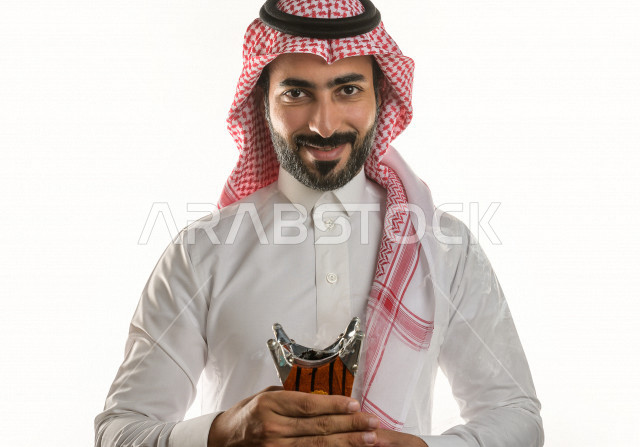 بورتريه لرجل عربي سعودي  يحمل حامل البخور( المبخرة ) ، استخدام خشب العود في المناسبات الاجتماعية و المناسبات الدينية ،  اصالة العادات و التقاليد في المملكة العربية السعودية ، التطيب و التعطر