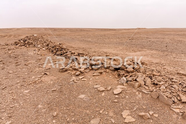 Cemetery in the desert of Riyadh, barren dirt lands, empty sandy terrain, desert environment in the Kingdom of Saudi Arabia,