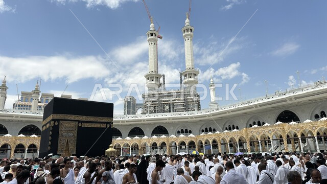 Performing Hajj and Umrah rituals, Islamic religious landmarks, the Noble Mosque of Mecca in the Kingdom of Saudi Arabia, the circumambulation of pilgrims and Umrah around the Noble Kaaba, worship and getting closer to God.