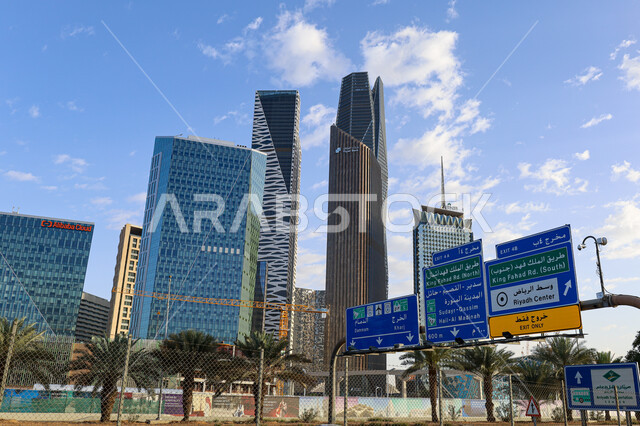 Interest in afforestation and planting palm trees, the architectural engineering art of economic towers and skyscrapers in the Kingdom of Saudi Arabia, famous landmarks of Riyadh, urban growth and progress in the modern style, the King Abdullah Financial Center in the city of Riyadh by day