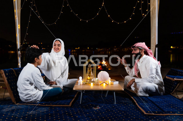 A wonderful family atmosphere for a Saudi Arabian Gulf family on a wonderful road trip to one of the tourist places in Saudi Arabia, they spend fun times full of love, affection and calm together, a family atmosphere, spending time with the family, Albran