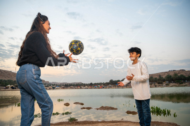 Two Saudi Gulf brothers spend wonderful times on a road trip in the desert of the Kingdom of Saudi Arabia at the time of sunrise, enjoyable wild weather in tourist desert areas, the beauty of the Saudi nature, land and camping