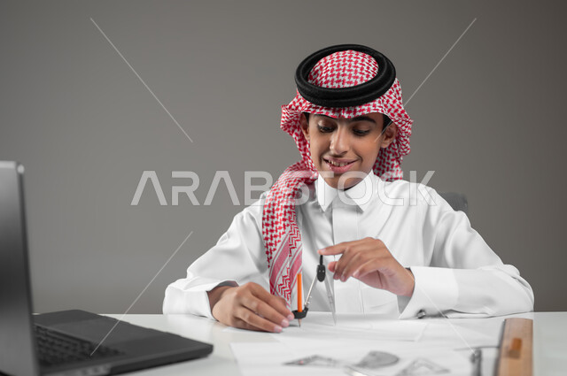 Using modern technical devices in scientific fields, drawing an engineering design diagram, gaining knowledge and experience with gestures of precision and focus, a close-up portrait of a Saudi Arabian Gulf boy wearing a shemagh and traditional thobe, sitting in front of his computer using engineering tools and equipment, gray background, sensitive content, sensitive use