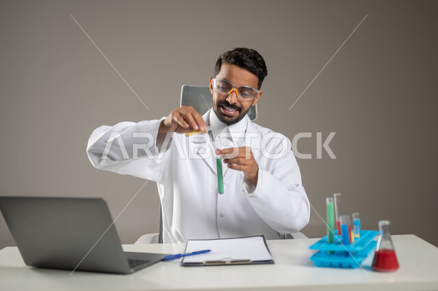 Research, development and progress of biotechnology, conducting studies and chemical reactions, using test tubes to conduct scientific experiments and research, a close-up portrait of a Saudi Arabian Gulf laboratory doctor examining analytical samples at his private office, gray background, sensitive content