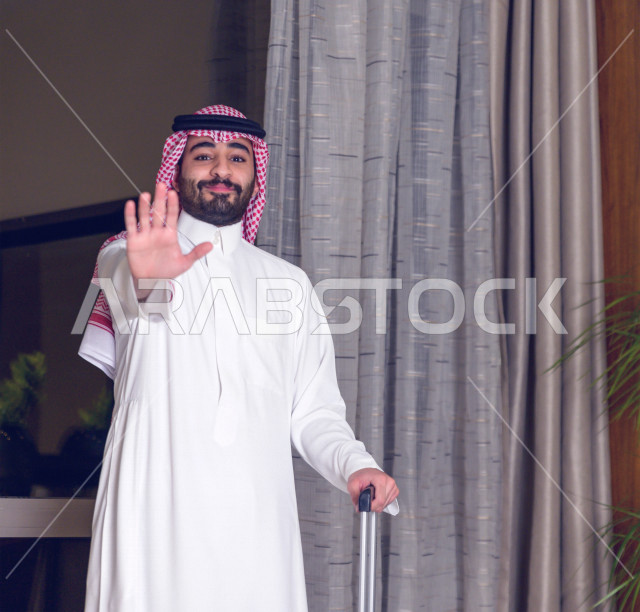 A Saudi Arabian Gulf man is traveling, holding a travel bag in his hand, emotional faces and hands, preparing for travel, tourism and travel.