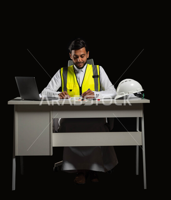 The role of structural engineering in the development of Saudi society, a close-up portrait of a Saudi Gulf Arab engineer wearing the traditional dress and work jacket, sitting at the desk and holding a pen in his hand on the engineering plan, drawing construction manuscripts, full-length body, black background, sensitive content, sensitive use
