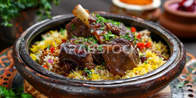 Popular traditional Arab feasts and dishes, a dish of kabsa rice with pieces of meat decorated with pepper and parsley, delicious food recipes, oriental food and meals, kitchens and restaurants in the Kingdom of Saudi Arabia