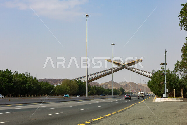 A model of the Qur’an Gate in the form of the Holy Qur’an on the highway, famous sacred religious places, travel and transportation between Jeddah and Mecca, traffic movement on roads and paved streets in the Kingdom of Saudi Arabia