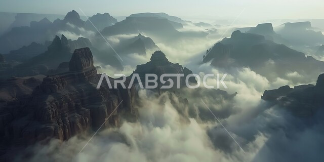 منظر الغيوم والسحب البيضاء في السماء تخترق سلسلة الجبال والتكوينات والتشكلات الصخرية في المناطق الصحراوية، الوديان والقمم الصخرية في البراري، اماكن سياحية مشهورة في المملكة العربية السعودية