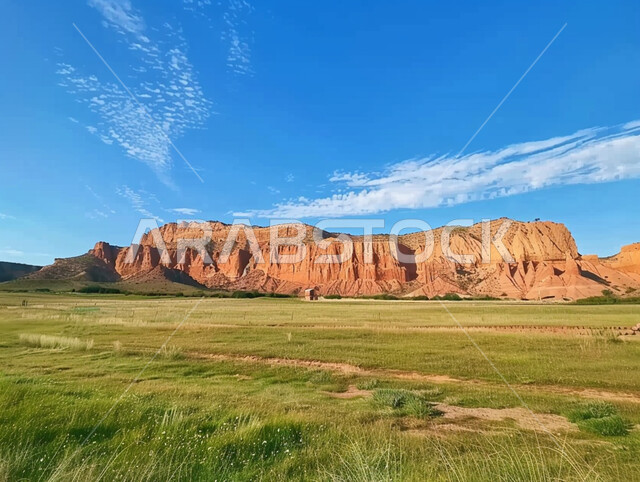 Mountain formations and formations, places of rocky slopes in the Kingdom of Saudi Arabia, areas for tourism and spending a pleasant time, green wild plants during the day, enjoying the natural scenery