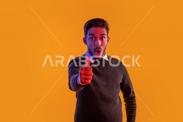 Portrait of a happy Saudi Gulf man, different face and hands gestures indicating happiness and joy, vitality and entertainment, colorful background