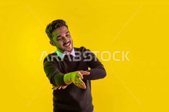 Portrait of a happy Saudi Gulf man, different face and hands gestures indicating happiness and joy, vitality and entertainment, colorful background