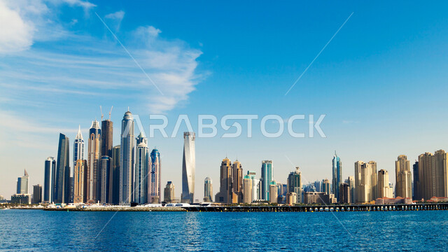 Architectural engineering art for buildings and facilities overlooking the artificial sea, growth, progress and urban expansion, view of towers and skyscrapers in the United Arab Emirates, Dubai tourist attractions, waterfront on the Arabian Gulf coast