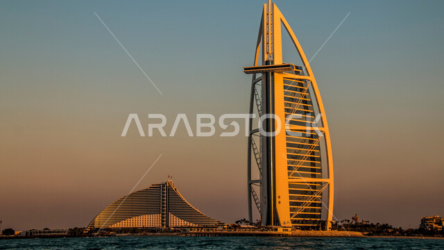 النمو والتطور العمراني على ساحل الخليج العربي، برج العرب في امارة دبي وقت غروب الشمس، الفن الهندسي المعماري للأبراج وناطحات السحاب، جذب واستقطاب السياح من انحاء العالم