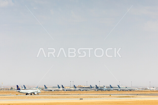 Means of transportation and air transportation, providing advanced services for easy movement between countries, the concept of tourism and travel, a group of aircraft standing at Khalid International Airport in the city of Riyadh, Saudi airlines and companies