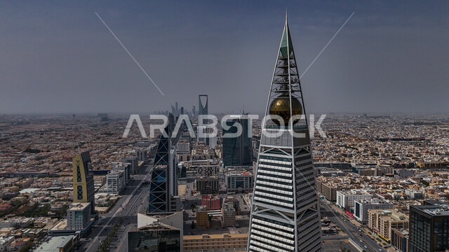 The economic and urban renaissance in Saudi Arabia, the modern and distinguished urban development in Riyadh, an aerial photograph of the Al Faisaliah Tower on King Fahd Road in Riyadh in broad daylight, towers and skyscrapers in the Kingdom, famous tourist attractions